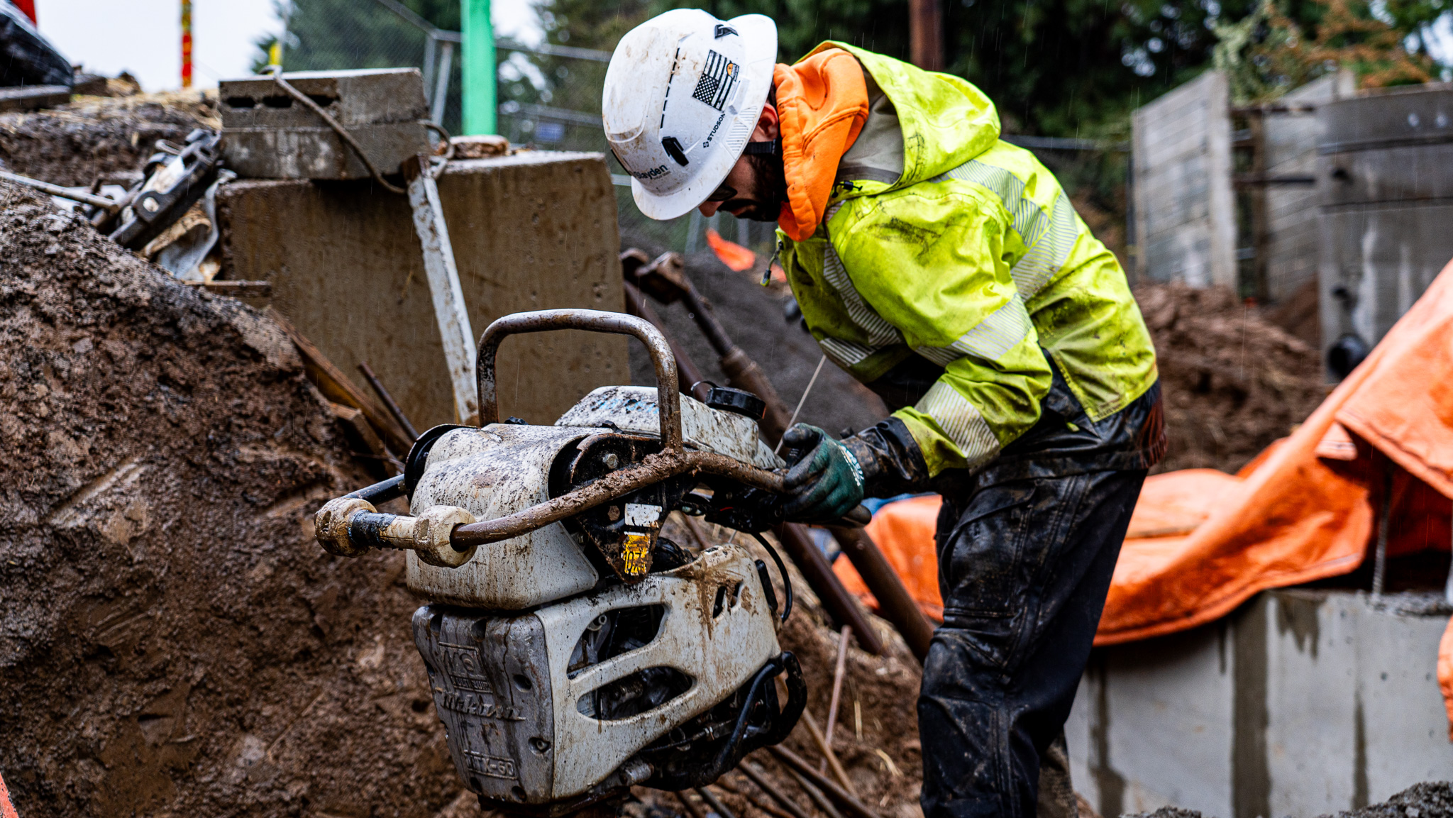 Slayden crew member in personal protective equipment working on a civil construction site